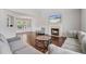 Bright living room featuring hardwood floors, a fireplace, and comfortable seating arrangement at 335 Lee Miller Ct, Suwanee, GA 30024