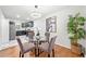 Open dining and kitchen area with stainless appliances and a round glass table at 801 N Evelyn Nw, Atlanta, GA 30318