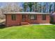 Charming brick home with a well-manicured lawn and a cozy front porch at 801 N Evelyn Nw, Atlanta, GA 30318