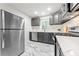 Bright kitchen featuring stainless steel appliances, modern gray cabinets, and white countertops at 801 N Evelyn Nw, Atlanta, GA 30318