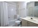 Clean bathroom with a bathtub and shower combination, ceramic tile, a classic toilet, and a vanity with sink at 1605 Ridenour Pkwy, Kennesaw, GA 30152