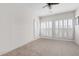 Spacious bedroom features plush carpet, white walls, plantation shutters, and ample natural light at 1605 Ridenour Pkwy, Kennesaw, GA 30152