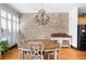 Elegant dining room features a brick accent wall, hardwood floors and natural light at 1605 Ridenour Pkwy, Kennesaw, GA 30152