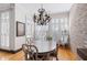 Elegant dining room features a brick accent wall, hardwood floors and natural light at 1605 Ridenour Pkwy, Kennesaw, GA 30152