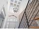 Grand foyer showcases a high ceiling, modern chandelier, brick wall accent, and elegant staircase with iron railing at 1605 Ridenour Pkwy, Kennesaw, GA 30152