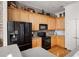 Bright kitchen features light wood cabinets, modern black appliances and brick accent wall at 1605 Ridenour Pkwy, Kennesaw, GA 30152