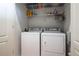 Functional laundry room features a washer, dryer, and storage shelves for detergents and laundry essentials at 1605 Ridenour Pkwy, Kennesaw, GA 30152