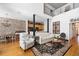Open concept living space showcases a dining room, kitchen, and brick accent wall at 1605 Ridenour Pkwy, Kennesaw, GA 30152
