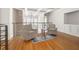 Cozy loft area features seating, natural light, hardwood floors, and iron railing overlooking the main floor at 1605 Ridenour Pkwy, Kennesaw, GA 30152
