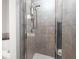Bathroom shower featuring custom tile work, glass doors and a built in rack at 1605 Ridenour Pkwy, Kennesaw, GA 30152
