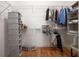 Organized walk-in closet featuring wooden floors, shelving, and ample hanging storage for clothing and accessories at 1605 Ridenour Pkwy, Kennesaw, GA 30152