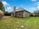Backyard featuring a grassy lawn and a view of the back exterior of the house at 200 Pine Trl, Dallas, GA 30157