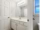 Bathroom featuring a white vanity with a large mirror and a view into an adjacent bathroom space at 200 Pine Trl, Dallas, GA 30157