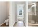 Neutral bathroom featuring a tiled shower and view to a well-lit bedroom at 200 Pine Trl, Dallas, GA 30157
