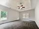 Spacious bedroom featuring neutral walls, carpet, tray ceiling, and a ceiling fan for added comfort at 200 Pine Trl, Dallas, GA 30157