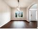 A bright, minimalist dining room with wood floors and a view of the front yard at 200 Pine Trl, Dallas, GA 30157