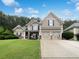 Charming two-story home featuring a well-manicured lawn and a convenient two-car garage at 200 Pine Trl, Dallas, GA 30157