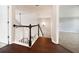 Upstairs hallway features hardwood flooring and wooden railing, connecting the home's upper level at 200 Pine Trl, Dallas, GA 30157
