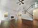 An open-concept living room with a fireplace, hardwood floors and a staircase at 200 Pine Trl, Dallas, GA 30157
