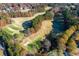 Stunning aerial view of community golf course surrounded by colorful, mature trees at 2001 Towne Lake W Hls, Woodstock, GA 30189