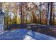 A spacious backyard deck with wood flooring provides an extension of the living area, nestled amongst trees at 2001 Towne Lake W Hls, Woodstock, GA 30189