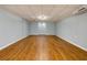 Spacious basement area with wood flooring and potential for various uses at 2001 Towne Lake W Hls, Woodstock, GA 30189