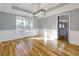 Bright dining room featuring hardwood floors, modern light fixture, large window, and stylish wall trim at 2001 Towne Lake W Hls, Woodstock, GA 30189