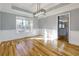Bright dining room features hardwood floors, modern light fixture, and large window overlooking the yard at 2001 Towne Lake W Hls, Woodstock, GA 30189