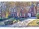 Stately brick home boasts a driveway and attached garage at 2001 Towne Lake W Hls, Woodstock, GA 30189