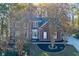 Charming brick two-story home featuring a well-manicured lawn and mature trees at 2001 Towne Lake W Hls, Woodstock, GA 30189