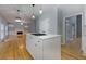 Modern kitchen featuring white cabinets, stainless steel appliances, and center island with gas cooktop at 2001 Towne Lake W Hls, Woodstock, GA 30189