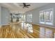 Open floorplan with hardwood floors flowing from a cozy living area into a modern kitchen and dining space at 2001 Towne Lake W Hls, Woodstock, GA 30189