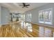 Open living room featuring hardwood floors, ceiling fan, and an attached kitchen at 2001 Towne Lake W Hls, Woodstock, GA 30189