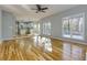 Open-concept living room with hardwood floors leading into a bright kitchen at 2001 Towne Lake W Hls, Woodstock, GA 30189