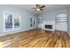 Spacious living room with fireplace, built-in shelves, and hardwood flooring at 2001 Towne Lake W Hls, Woodstock, GA 30189