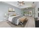 Bright main bedroom with a tray ceiling, sitting area, and plush carpet at 2001 Towne Lake W Hls, Woodstock, GA 30189