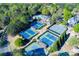 Aerial view of well-maintained tennis courts surrounded by trees and landscaping at 2001 Towne Lake W Hls, Woodstock, GA 30189