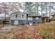 Back of split level home with painted brick, small basement entry, and a fenced-in yard at 2475 Harvel Nw Dr, Atlanta, GA 30318