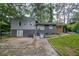 Exterior view of home with brick siding and paved patio and yard area at 2475 Harvel Nw Dr, Atlanta, GA 30318