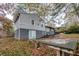 Back of split level home with painted brick and a walkout patio and basement entry at 2475 Harvel Nw Dr, Atlanta, GA 30318