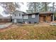 Back of split level home with painted brick, small basement entry, and a fenced-in yard at 2475 Harvel Nw Dr, Atlanta, GA 30318