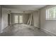 Unfinished basement with cement floor, window and double doors at 2475 Harvel Nw Dr, Atlanta, GA 30318