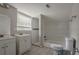 Bathroom featuring tiled shower, tub, toilet, and double sink with vanity at 2475 Harvel Nw Dr, Atlanta, GA 30318
