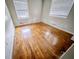 Empty bedroom with wood floors, white walls, and natural light from two windows at 2475 Harvel Nw Dr, Atlanta, GA 30318