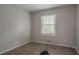 This bedroom has carpeted floors, a window, and an air conditioning unit at 2475 Harvel Nw Dr, Atlanta, GA 30318