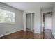 This bedroom has hardwood floors, a window, and a closet at 2475 Harvel Nw Dr, Atlanta, GA 30318