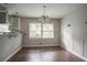 Bright dining space with large windows, hardwood floors, and modern lighting at 2475 Harvel Nw Dr, Atlanta, GA 30318