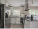 This kitchen features tile floors, an stainless steel refrigerator, and a black countertop at 2475 Harvel Nw Dr, Atlanta, GA 30318