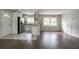Open floor plan showcasing a modern kitchen with stainless steel appliances and large windows at 2475 Harvel Nw Dr, Atlanta, GA 30318