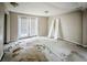 Spacious room with doors to the exterior, bare floors and two doors laying against the wall at 2475 Harvel Nw Dr, Atlanta, GA 30318